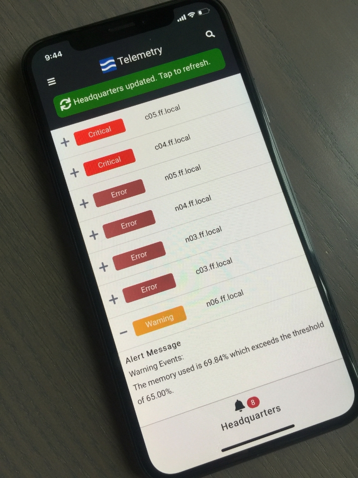 Phone sitting on table with FrameFlow's Telemetry app open and information from Headquarters displayed.